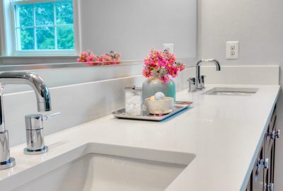The interior of a modern clean bathroom with white furniture
