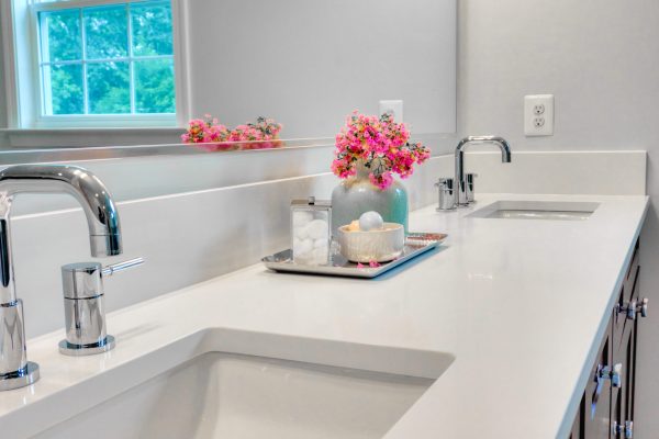 The interior of a modern clean bathroom with white furniture